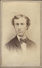 Young man wearing a coat and a bow tie
