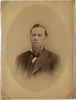 Bearded man in suit jacket, vest, with a bowtie